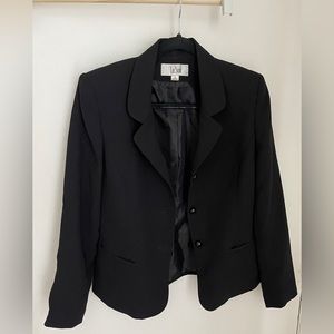 2 piece black skirt suit with ruffle edge.